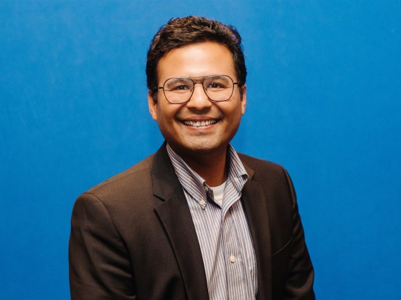 Headshot of board member, Nishesh Aggarwal smiling