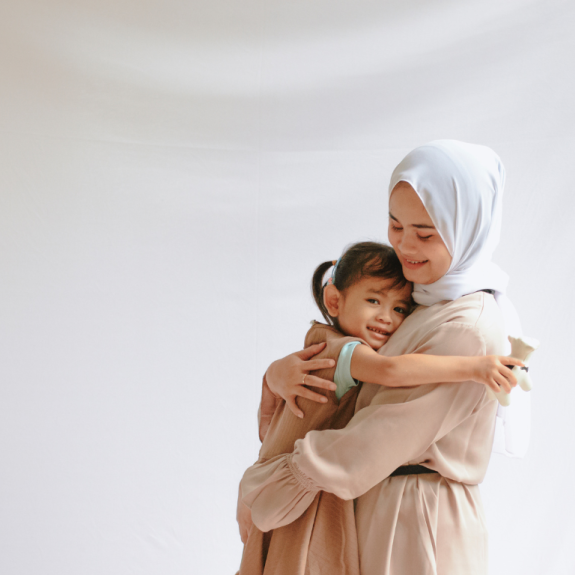 mother carrying daughter