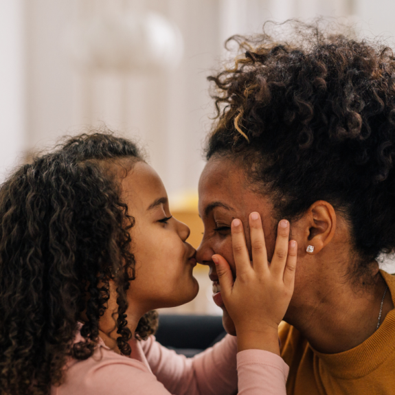 daughter kissing mom on nose