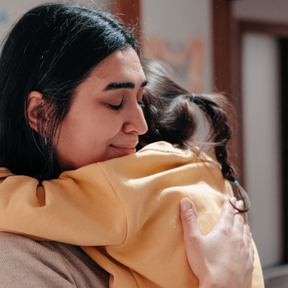 mom hugging little daughter