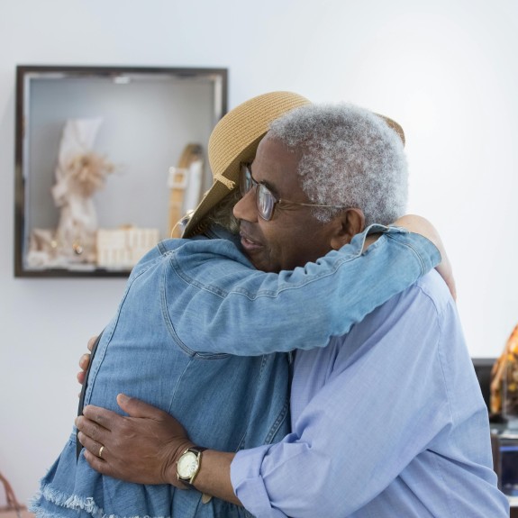 elderly couple hugging